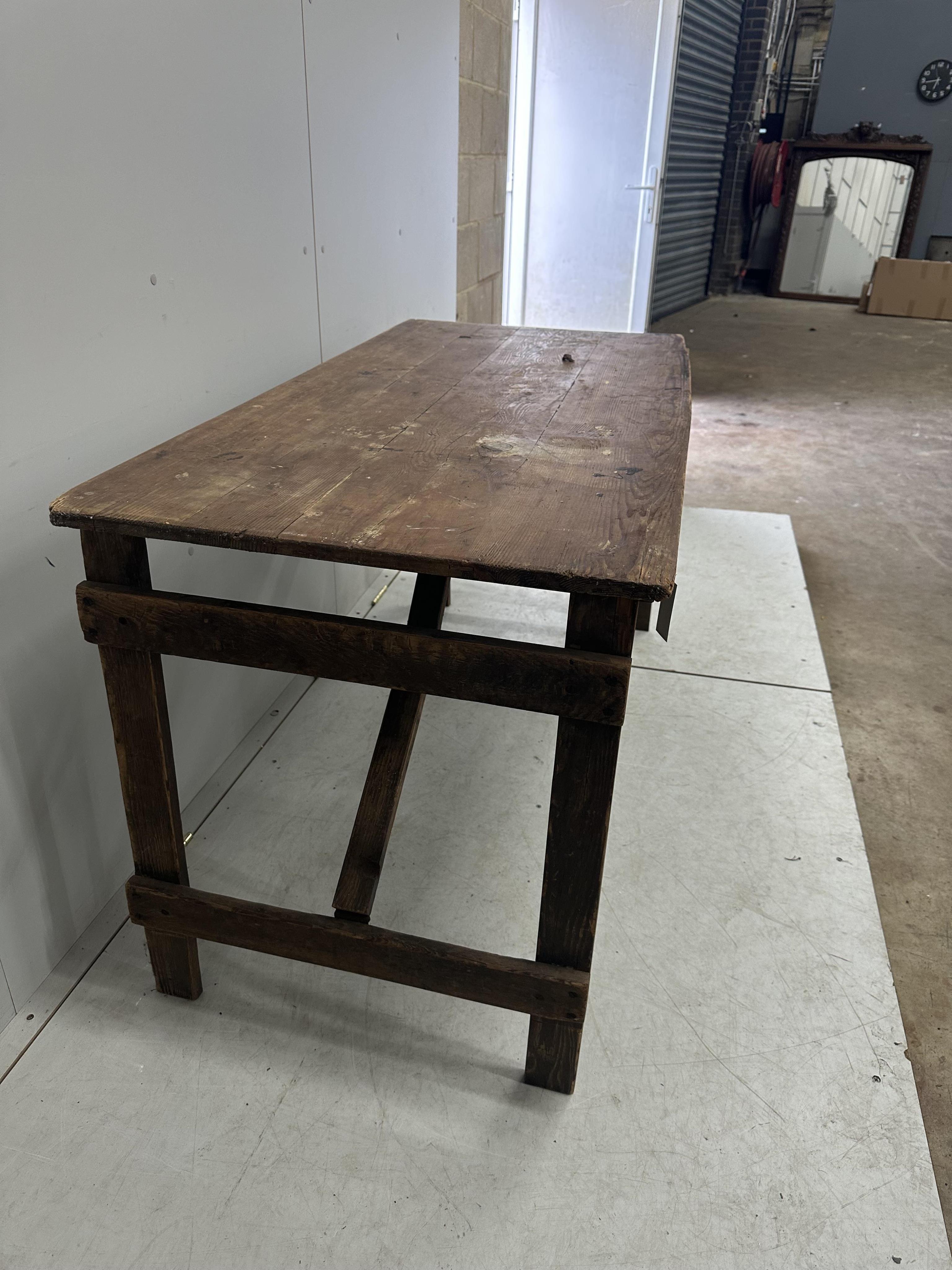 A folding pine trestle table, width 136cm, depth 67cm, height 74cm. Condition - poor